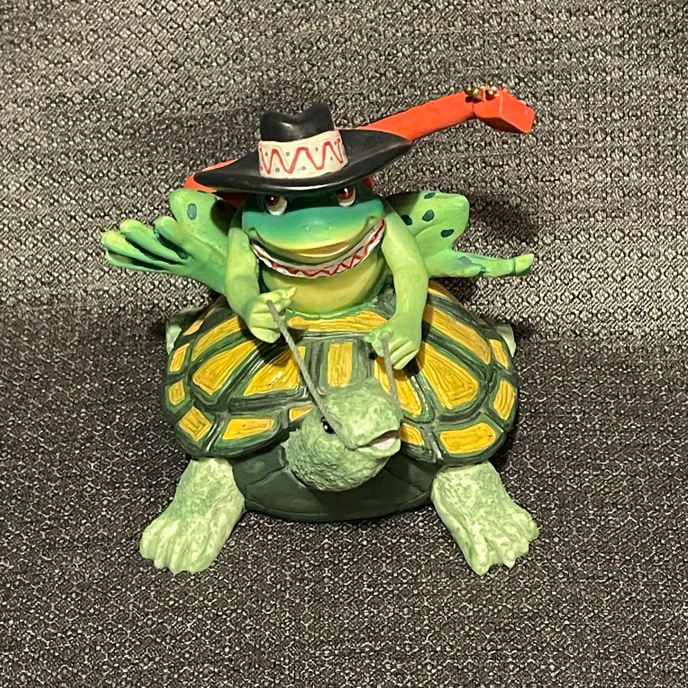 Guitar strapped turtle musical figurine.